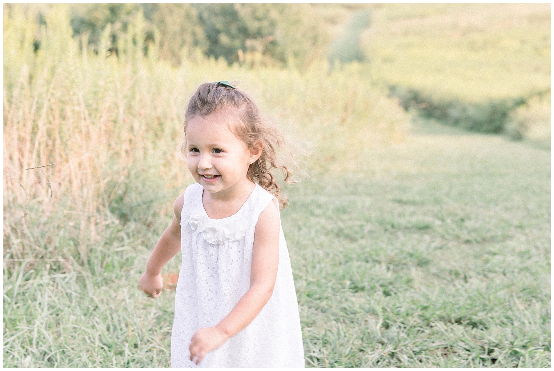 Baby girl running through field during sunset. Image taken by Katie Petrick Photography, Charlotte NC family photography