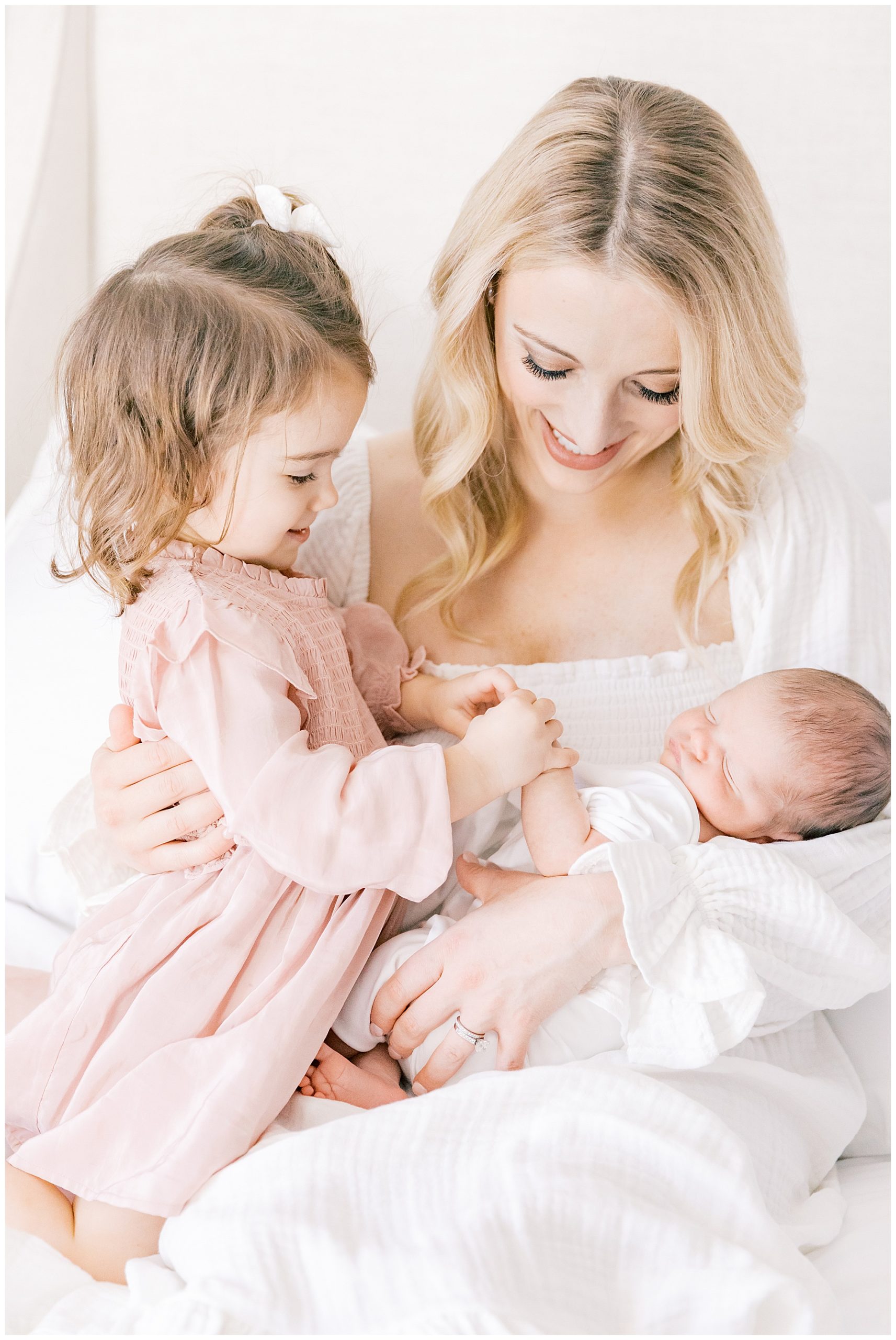 Mama holding her babies during newborn photography session