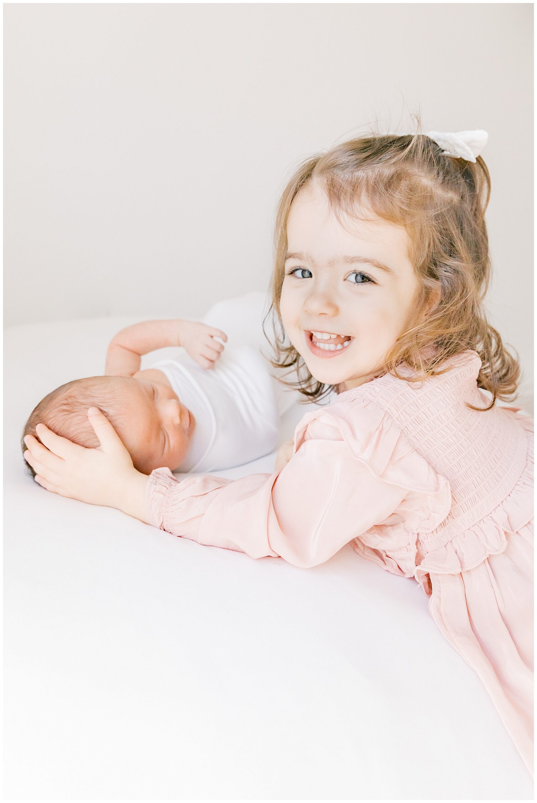 Big sister smiling with baby brother | Katie Petrick Phtography