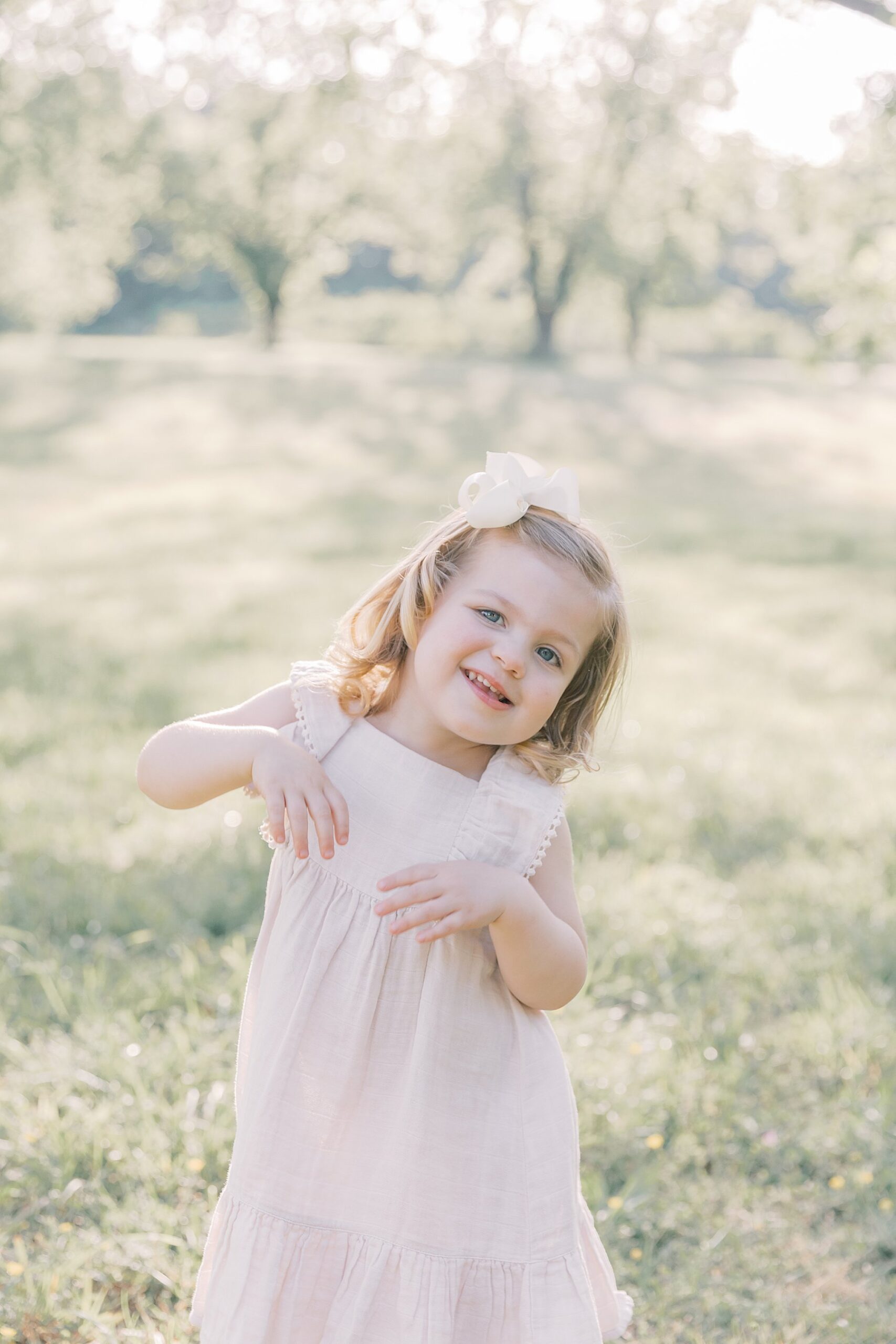toddler girl smiles during family photography session by Katie Petrick Photography