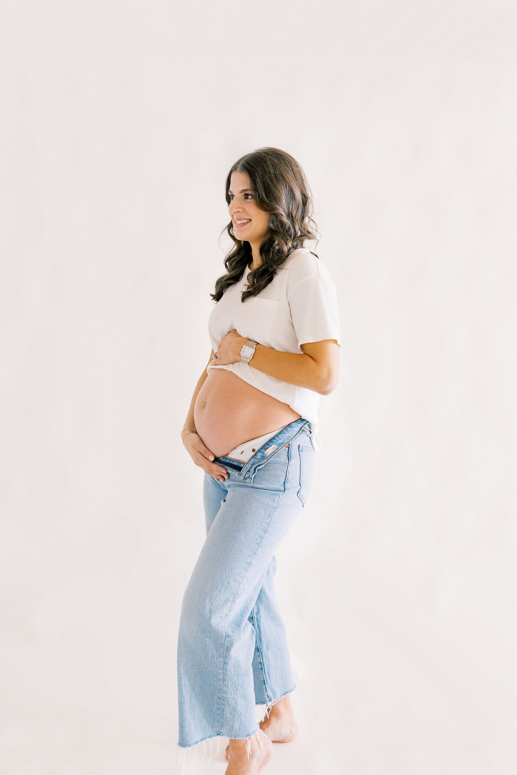 Expecting mother in Charlotte NC holding baby bump during pregnancy